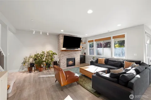 a living room with furniture a fireplace and a flat screen tv