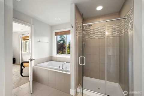 a bathroom with a tub and shower