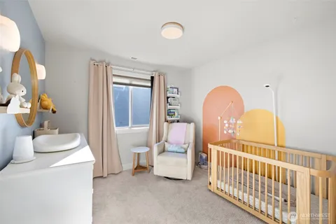 a bedroom with furniture and a large window