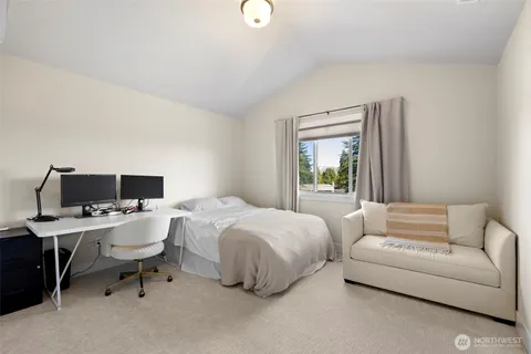 a bedroom with a bed and a desk