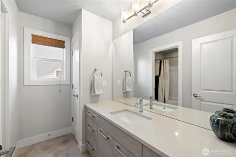 a bathroom with a double vanity sink and a mirror