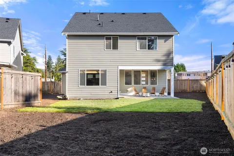 a front view of a house with swimming pool having outdoor seating