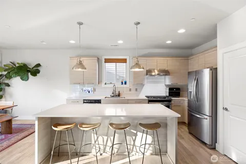 a kitchen with granite countertop a sink and stainless steel appliances