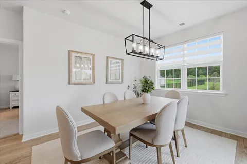 a view of a dining room with furniture window and outside view
