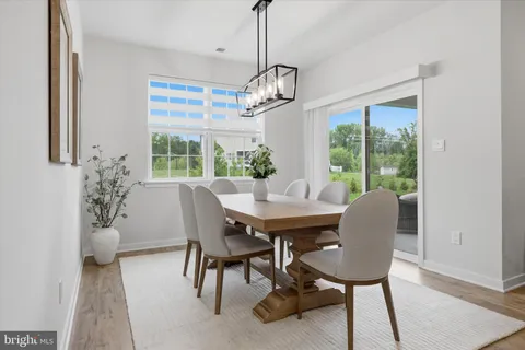 a view of a dining room with furniture and a chandelier