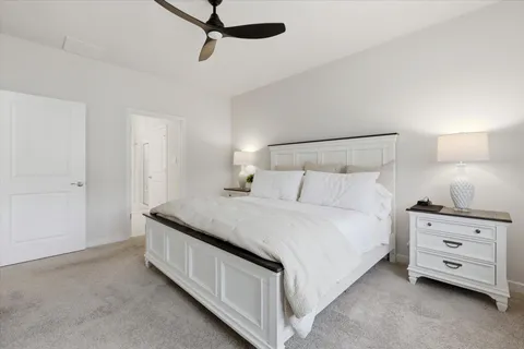 a spacious bedroom with a bed and window