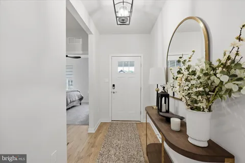 a kitchen with stainless steel appliances kitchen island granite countertop a table chairs and a refrigerator