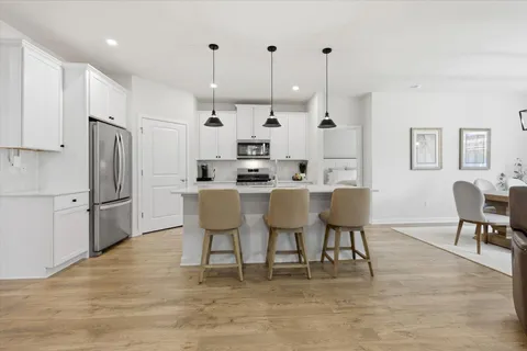 a kitchen with stainless steel appliances granite countertop a refrigerator stove microwave and sink