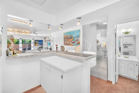 a large white kitchen with a large window