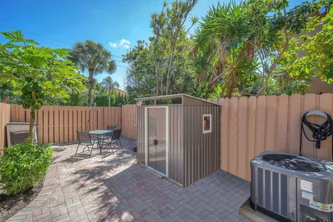 a view of a chair and table in backyard