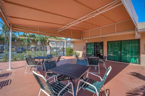 a view of a patio with a table and chairs