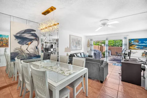 a kitchen with a stove a sink a dining table and chairs