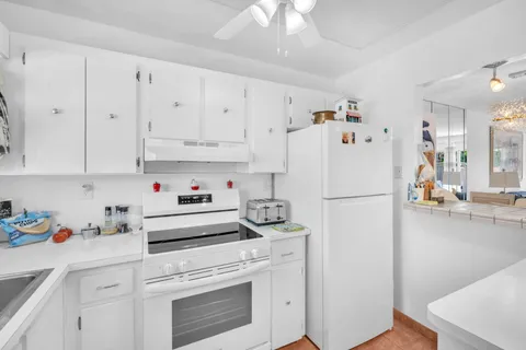 a white refrigerator freezer sitting in a kitchen
