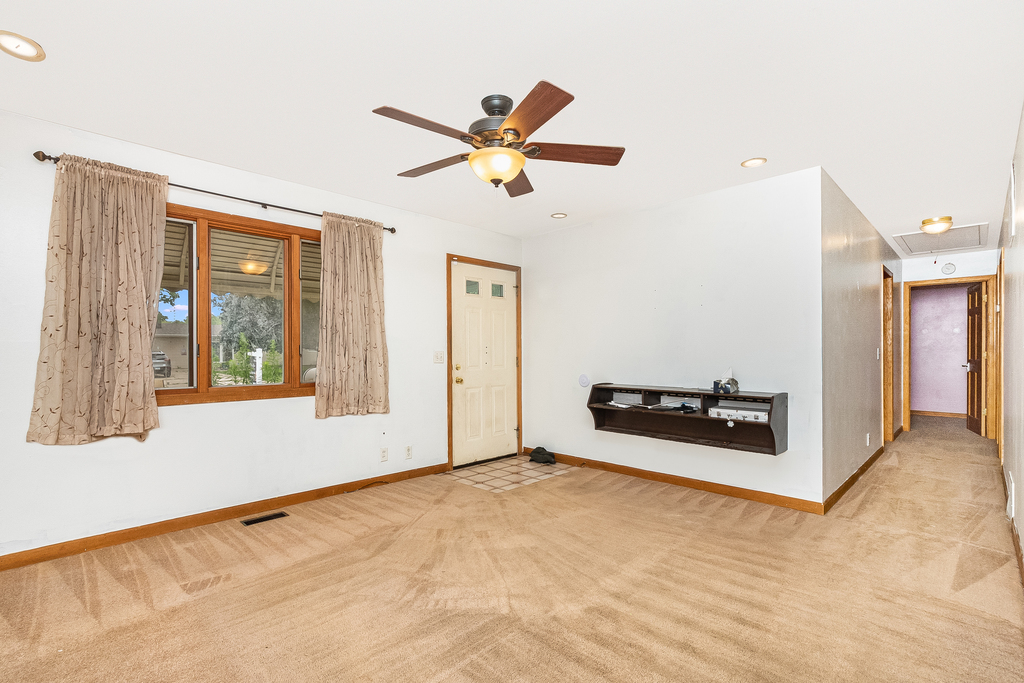 26 Saugatuck Road Montgomery, IL 60538 - Photo 2 of 15 a view of a livingroom with wooden floor and a ceiling fan