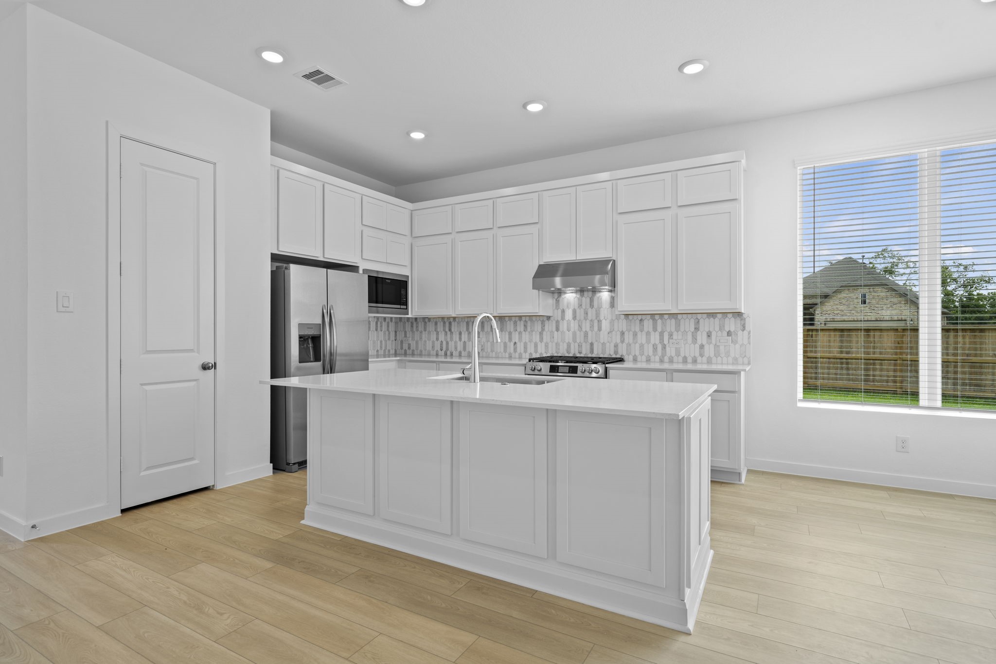 2720 Grove Crest Drive Rosenberg, TX 77469 - Photo 11 of 32 An additional view of this GORGEOUS Gourmet Kitchen that also offers custom tile backsplash, under cabinet lighting, crown molding, Breakfast Bar, extended island & High-End Stainless Steel Appliances.
