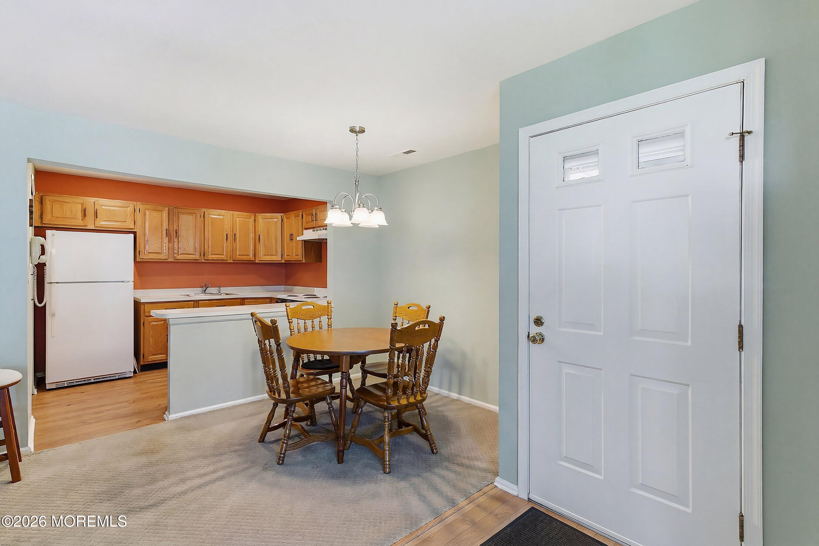 52 Honeysuckle Lane, Unit 220 Red Bank, NJ 07701 - Photo 12 of 25 a view of a dining room with furniture and window