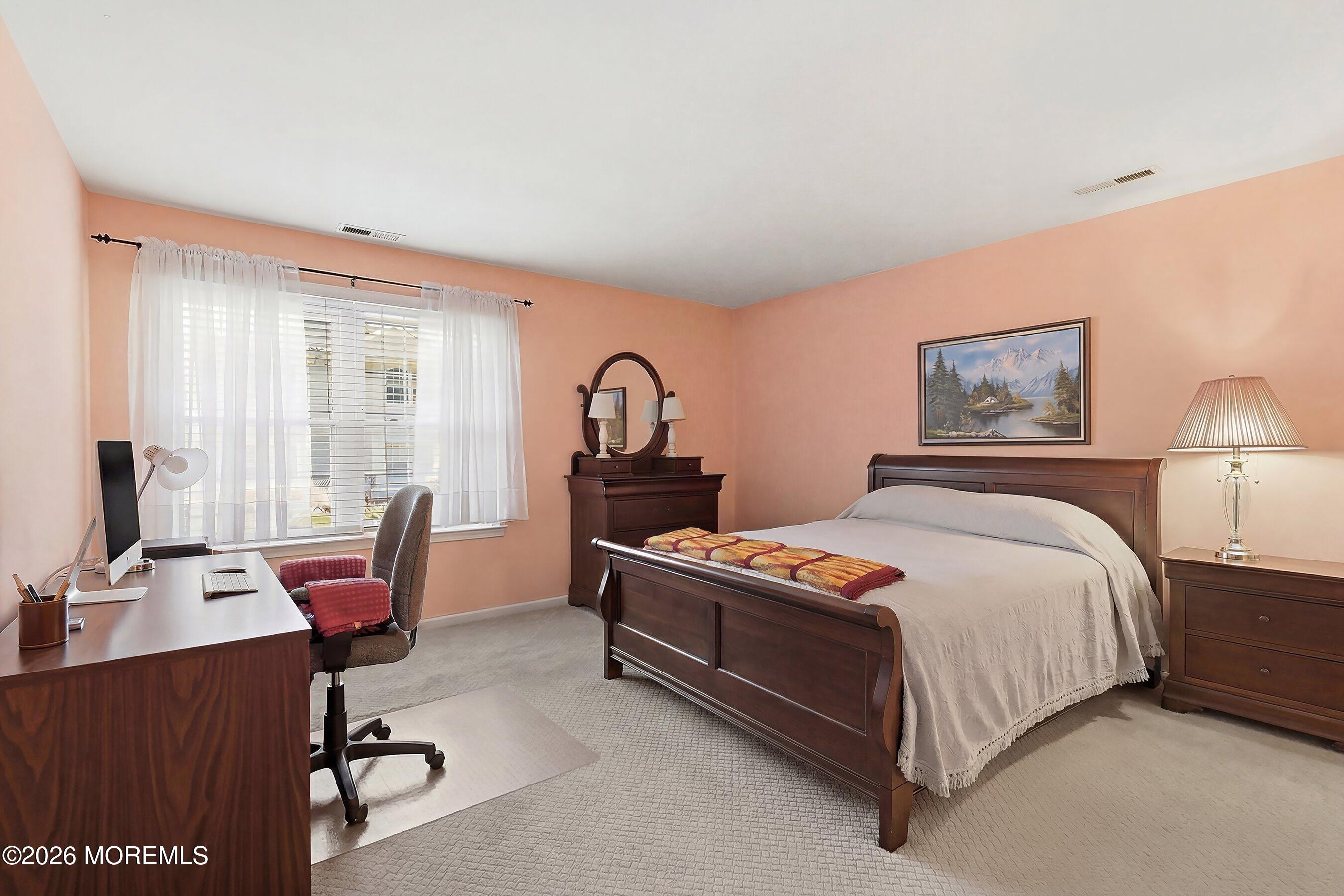 52 Honeysuckle Lane, Unit 220 Red Bank, NJ 07701 - Photo 13 of 25 a bedroom with a bed chair and a desk