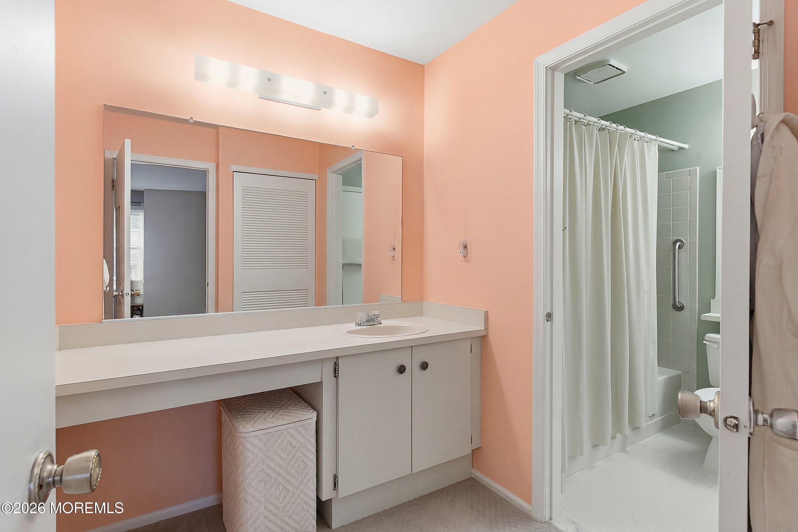 52 Honeysuckle Lane, Unit 220 Red Bank, NJ 07701 - Photo 15 of 25 a bathroom with a sink and a mirror