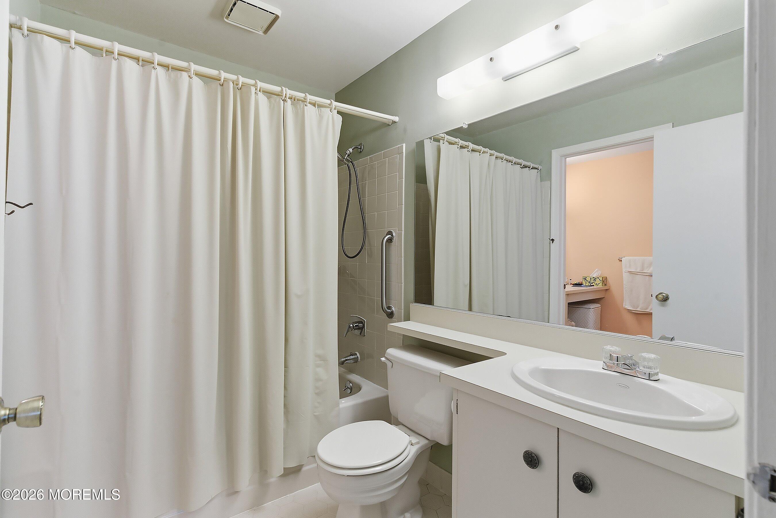 52 Honeysuckle Lane, Unit 220 Red Bank, NJ 07701 - Photo 16 of 25 a bathroom with a granite countertop sink toilet and mirror