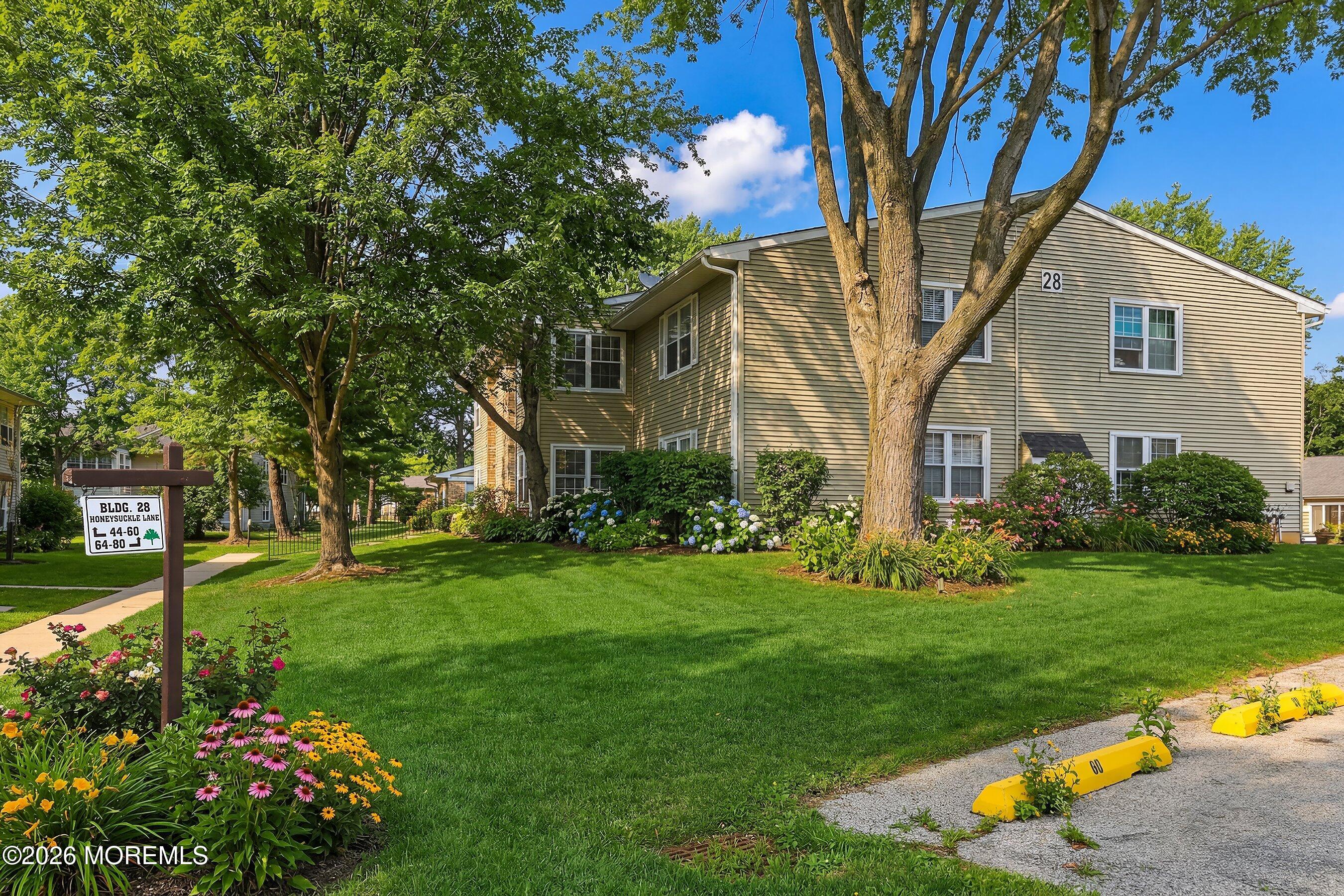 52 Honeysuckle Lane, Unit 220 Red Bank, NJ 07701 - Photo 25 of 25 a front view of a house with garden