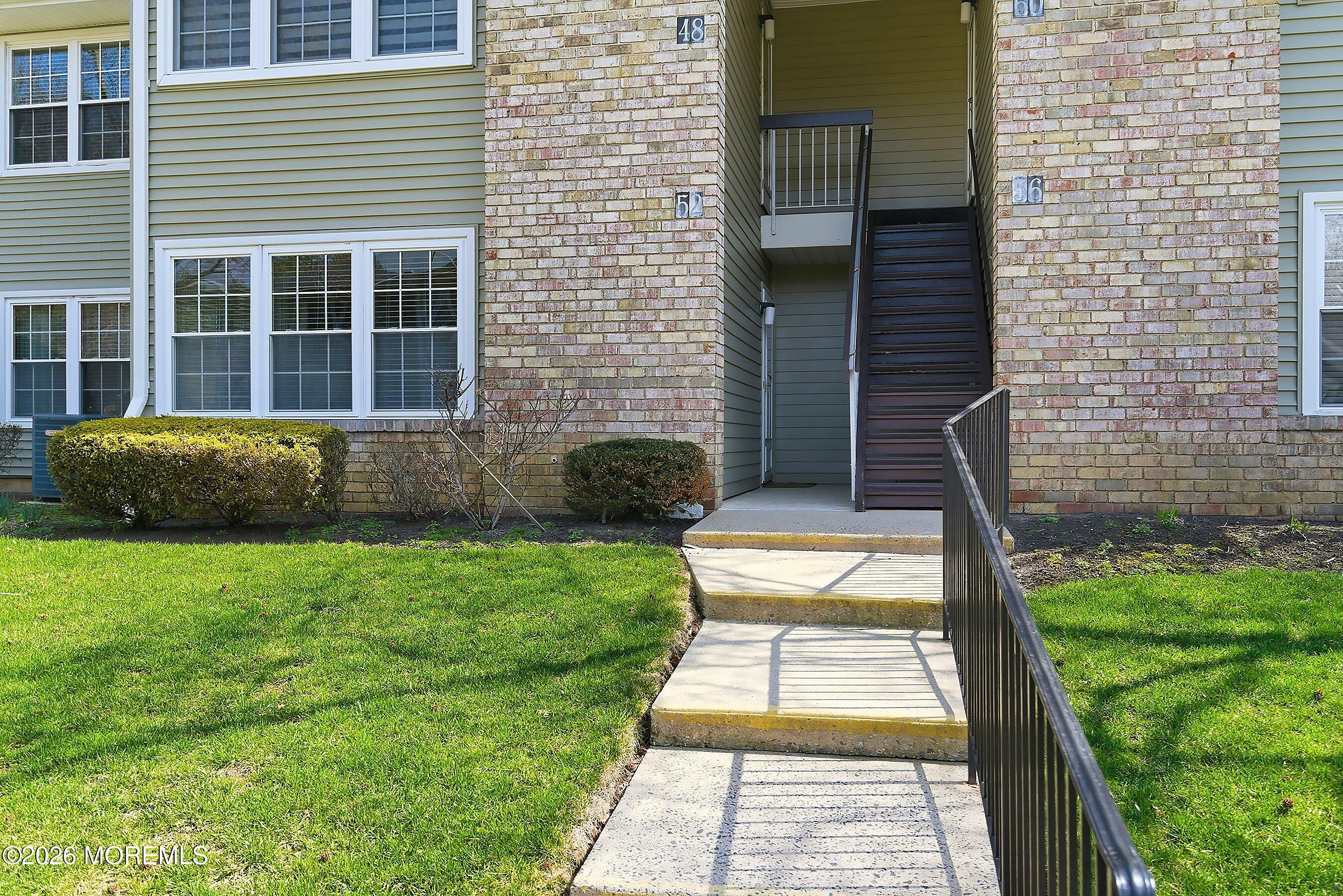 52 Honeysuckle Lane, Unit 220 Red Bank, NJ 07701 - Photo 3 of 25 a view of a backyard with a garden