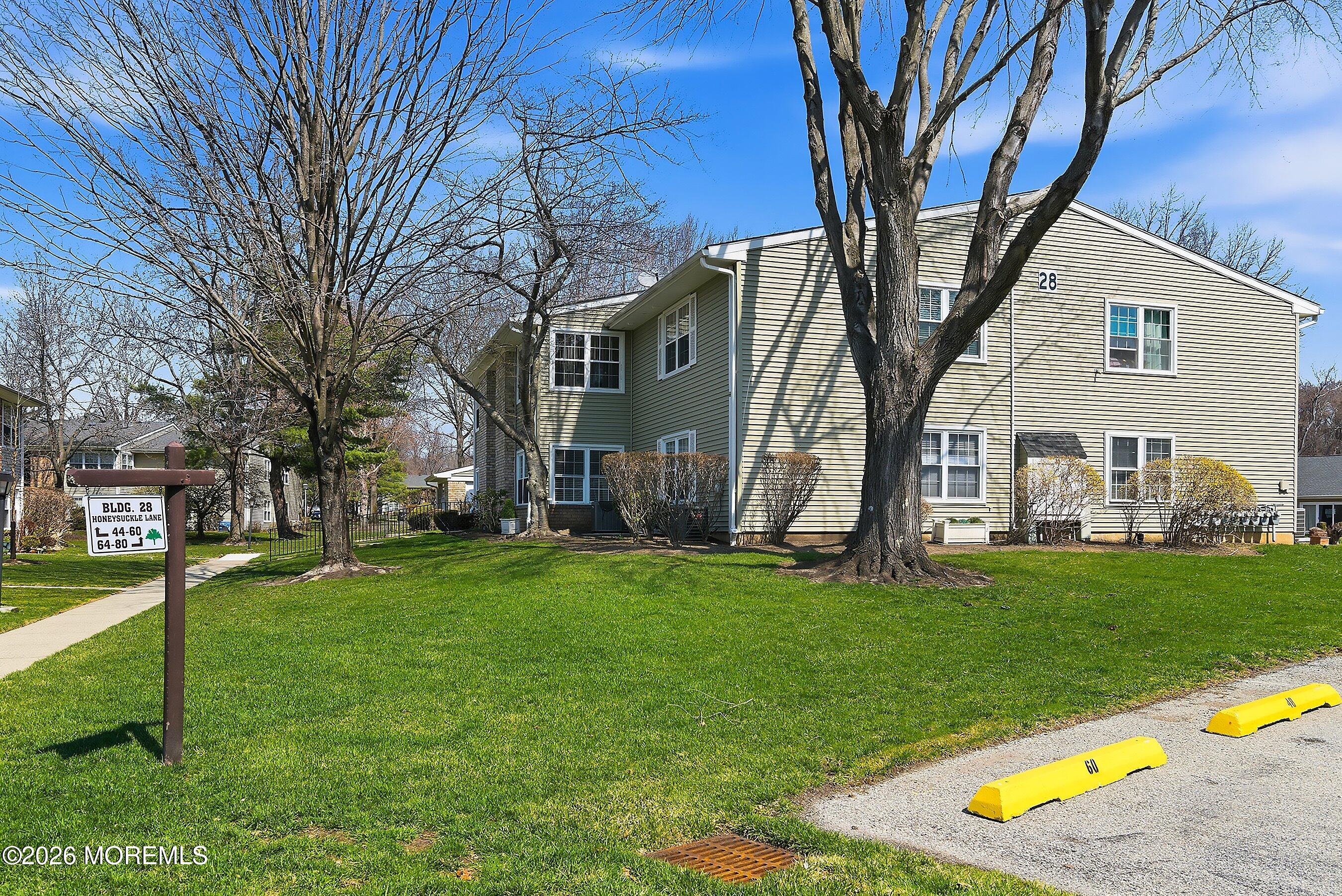 52 Honeysuckle Lane, Unit 220 Red Bank, NJ 07701 - Photo 4 of 25 a view of a house with backyard and a tree