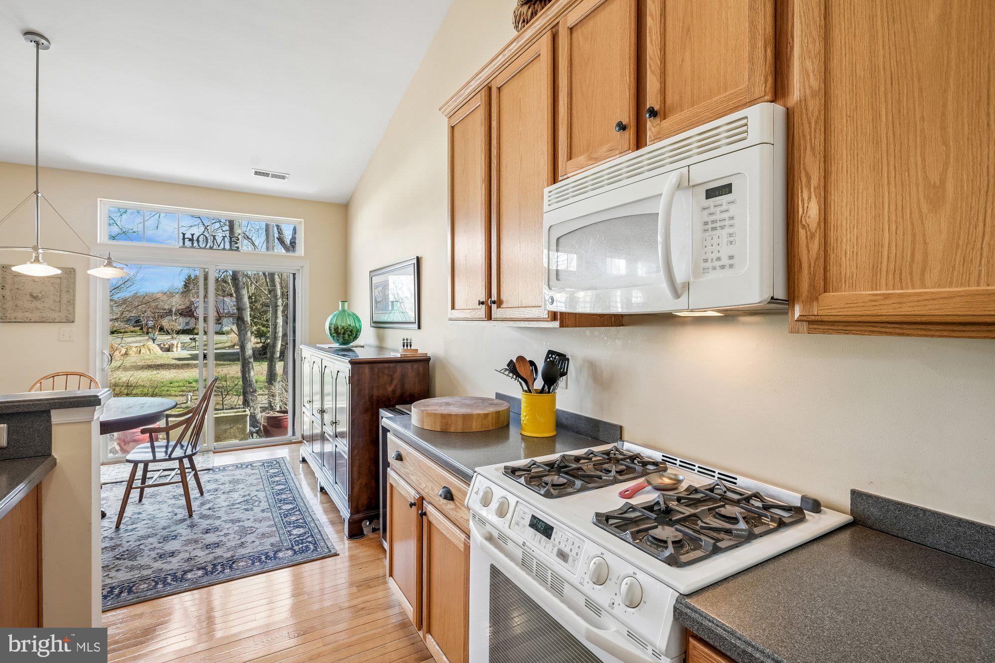 37151 Lord Baltimore Lane Ocean View, DE 19970 - Photo 17 of 68 a kitchen with stainless steel appliances granite countertop a stove a sink and a microwave