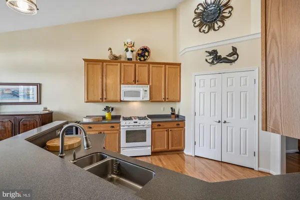 a view of kitchen with stainless steel appliances cabinets and wooden floor