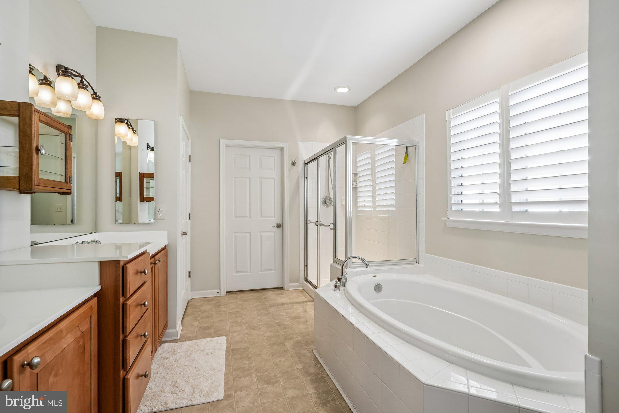 37151 Lord Baltimore Lane Ocean View, DE 19970 - Photo 29 of 68 a spacious bathroom with a granite countertop tub sink and mirror