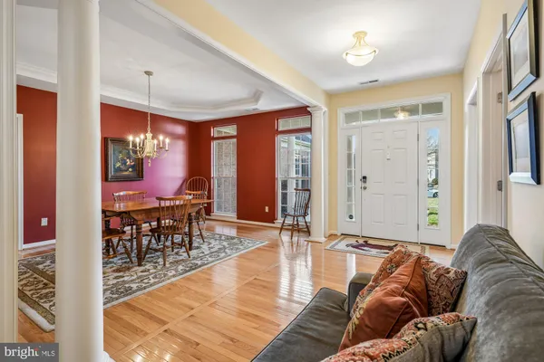 a living room with furniture a rug and a chandelier