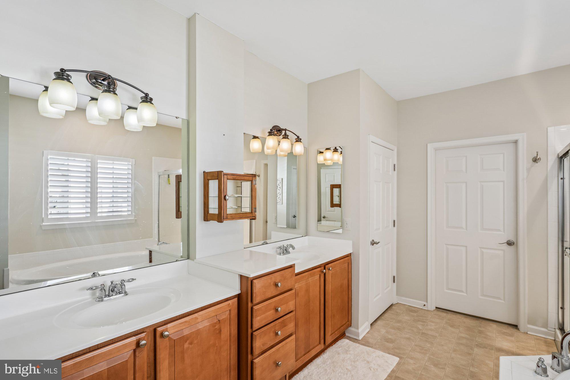 37151 Lord Baltimore Lane Ocean View, DE 19970 - Photo 33 of 68 a spacious bathroom with double vanity sink a mirror a window and a bathtub
