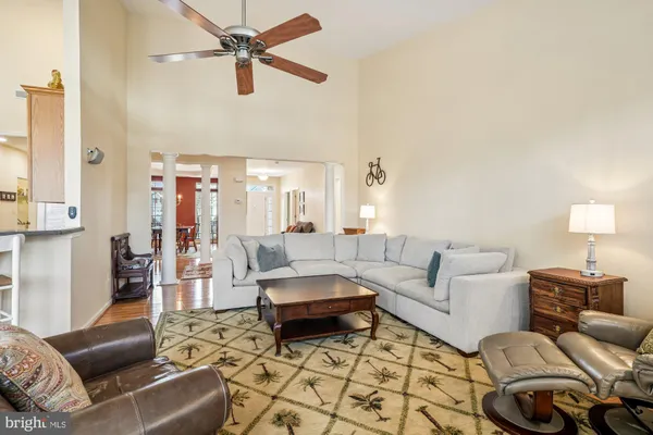 a living room with furniture a flat screen tv and a window