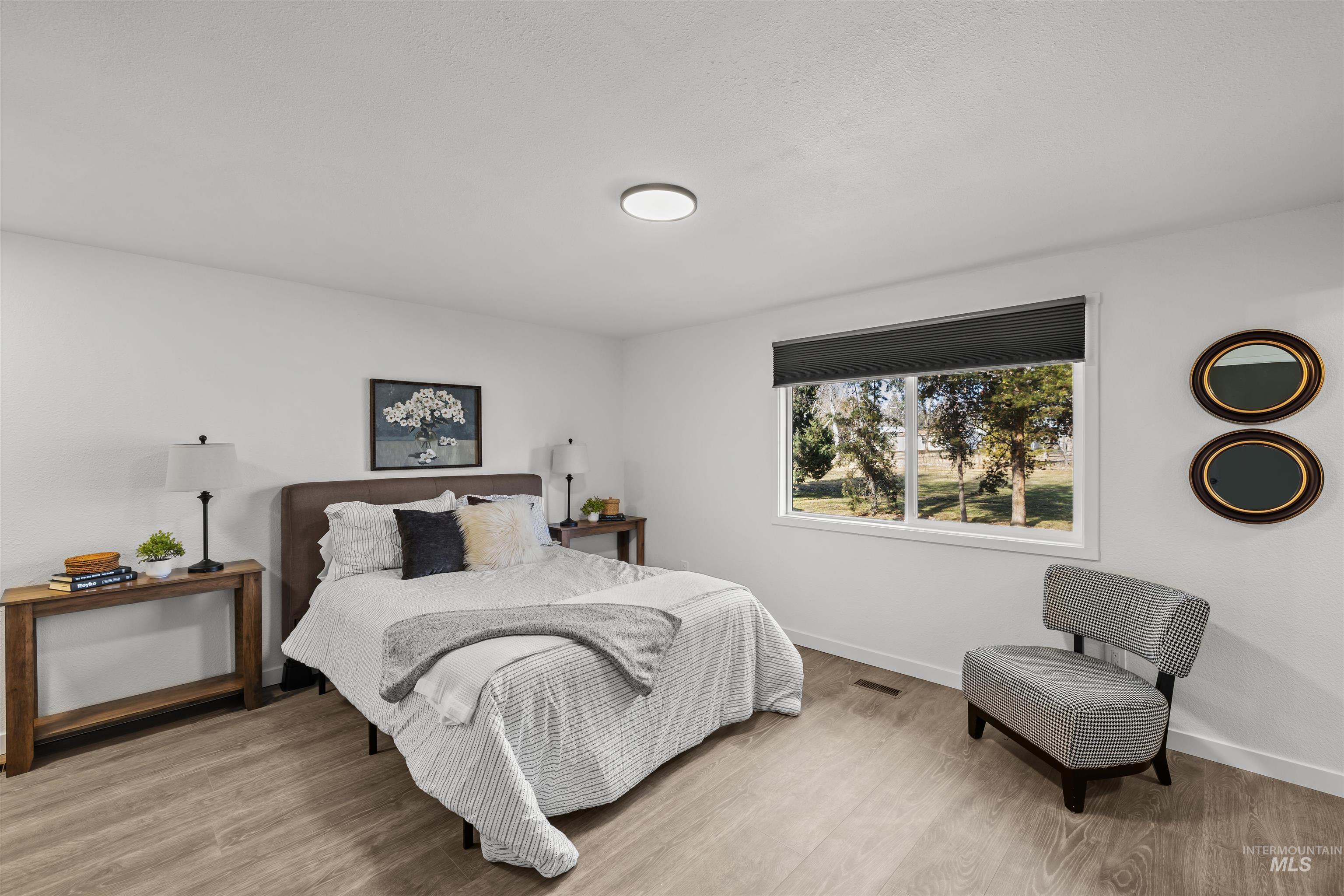 7144 West Diamond Street Boise, ID 83709 - Photo 12 of 47 Bedroom with wood finished floors and baseboards
