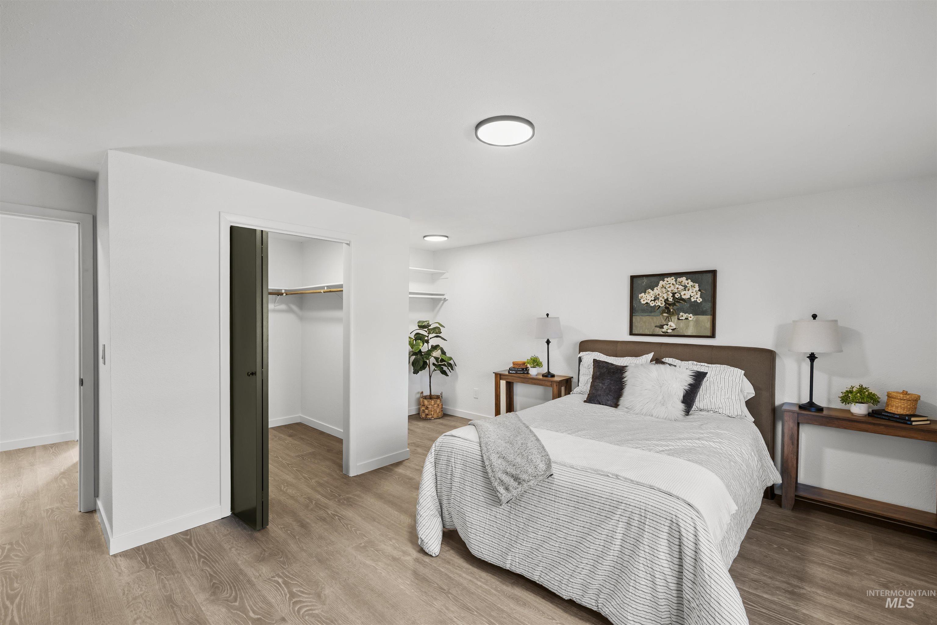 7144 West Diamond Street Boise, ID 83709 - Photo 14 of 47 Bedroom featuring a spacious closet and wood finished floors