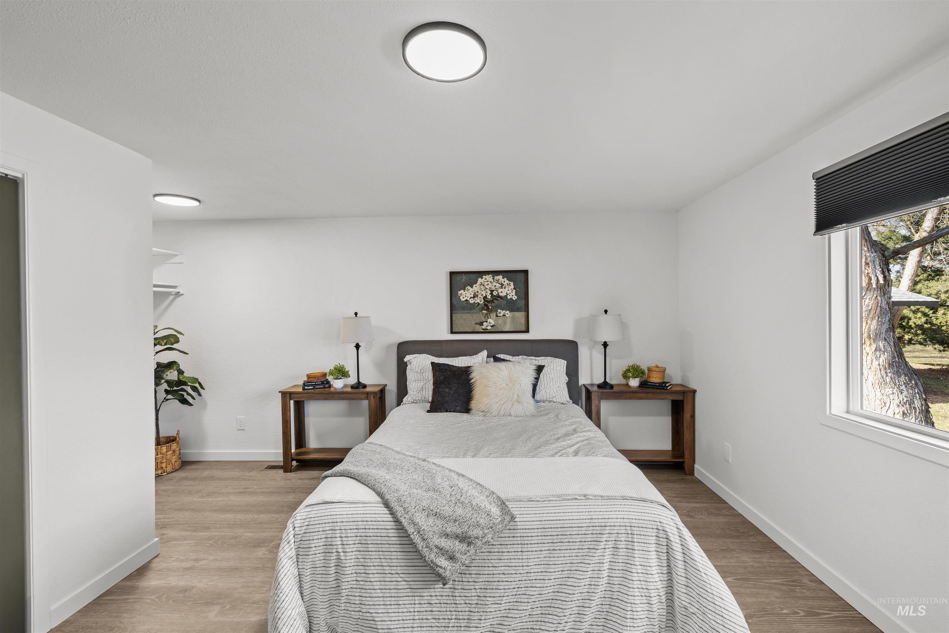 7144 West Diamond Street Boise, ID 83709 - Photo 15 of 47 Bedroom featuring light wood finished floors and baseboards