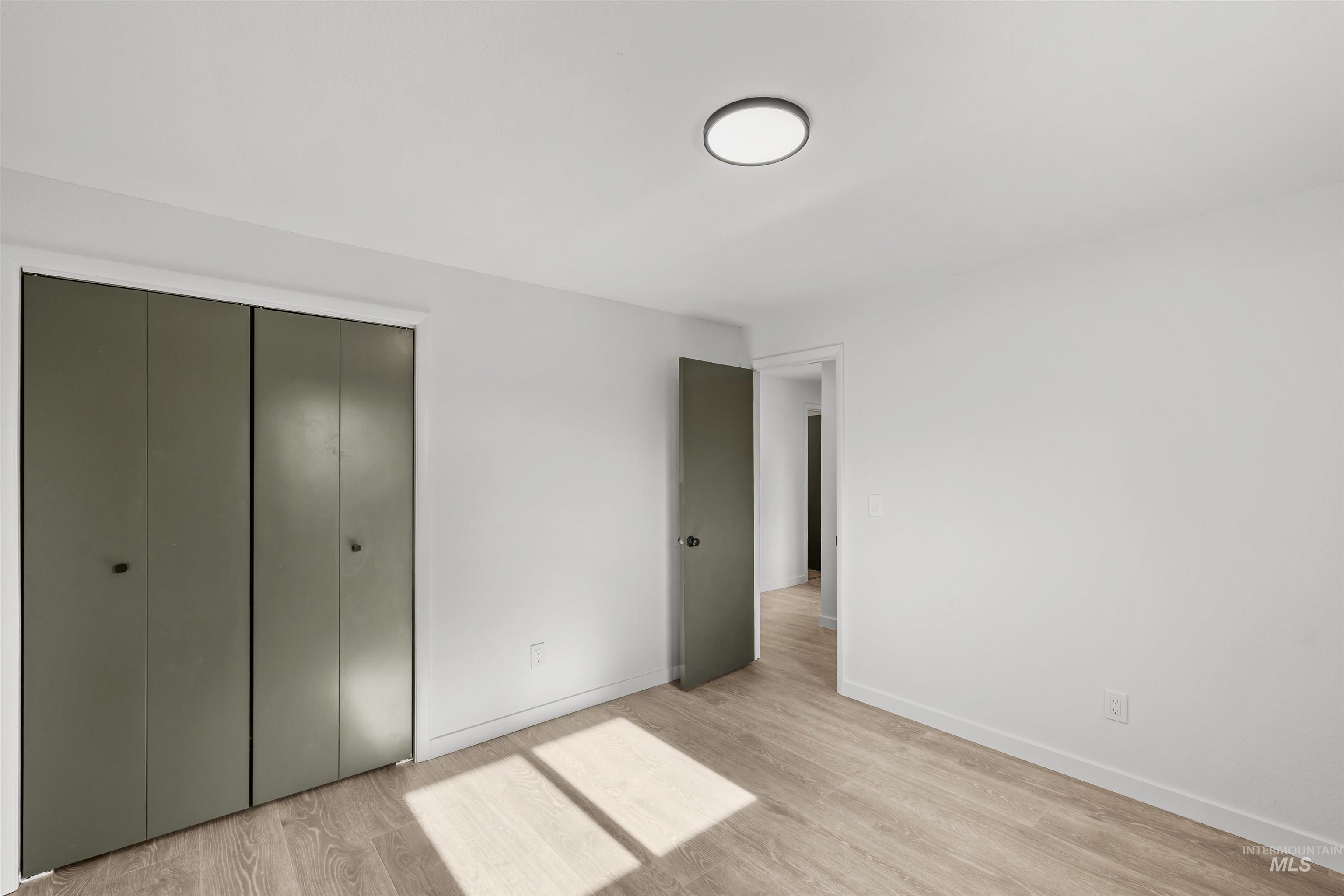 7144 West Diamond Street Boise, ID 83709 - Photo 20 of 47 Unfurnished bedroom featuring light wood-type flooring and a closet