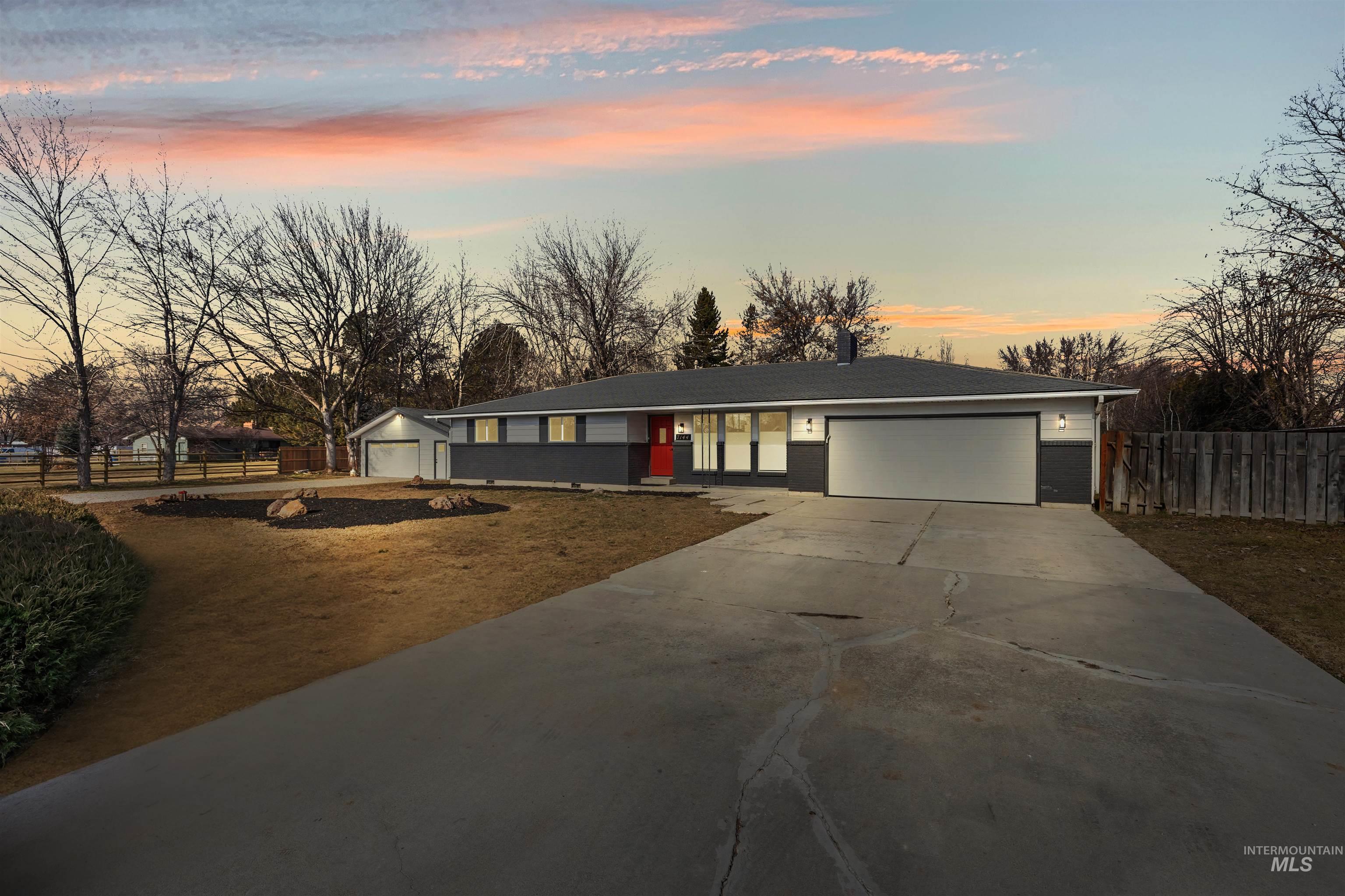 7144 West Diamond Street Boise, ID 83709 - Photo 2 of 47 Ranch-style house with concrete driveway, an attached garage, and brick siding