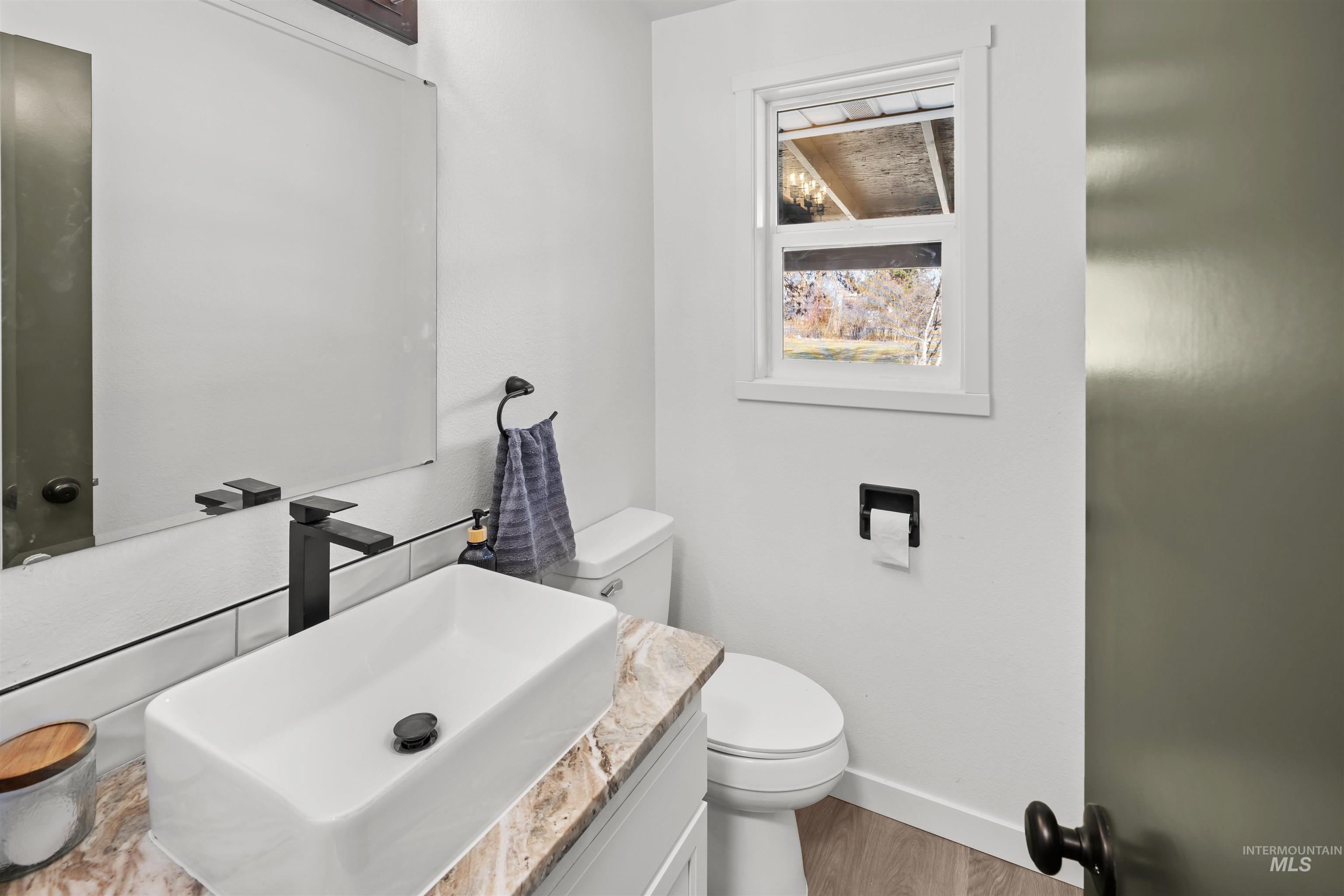 7144 West Diamond Street Boise, ID 83709 - Photo 26 of 47 Half bath featuring vanity and wood finished floors