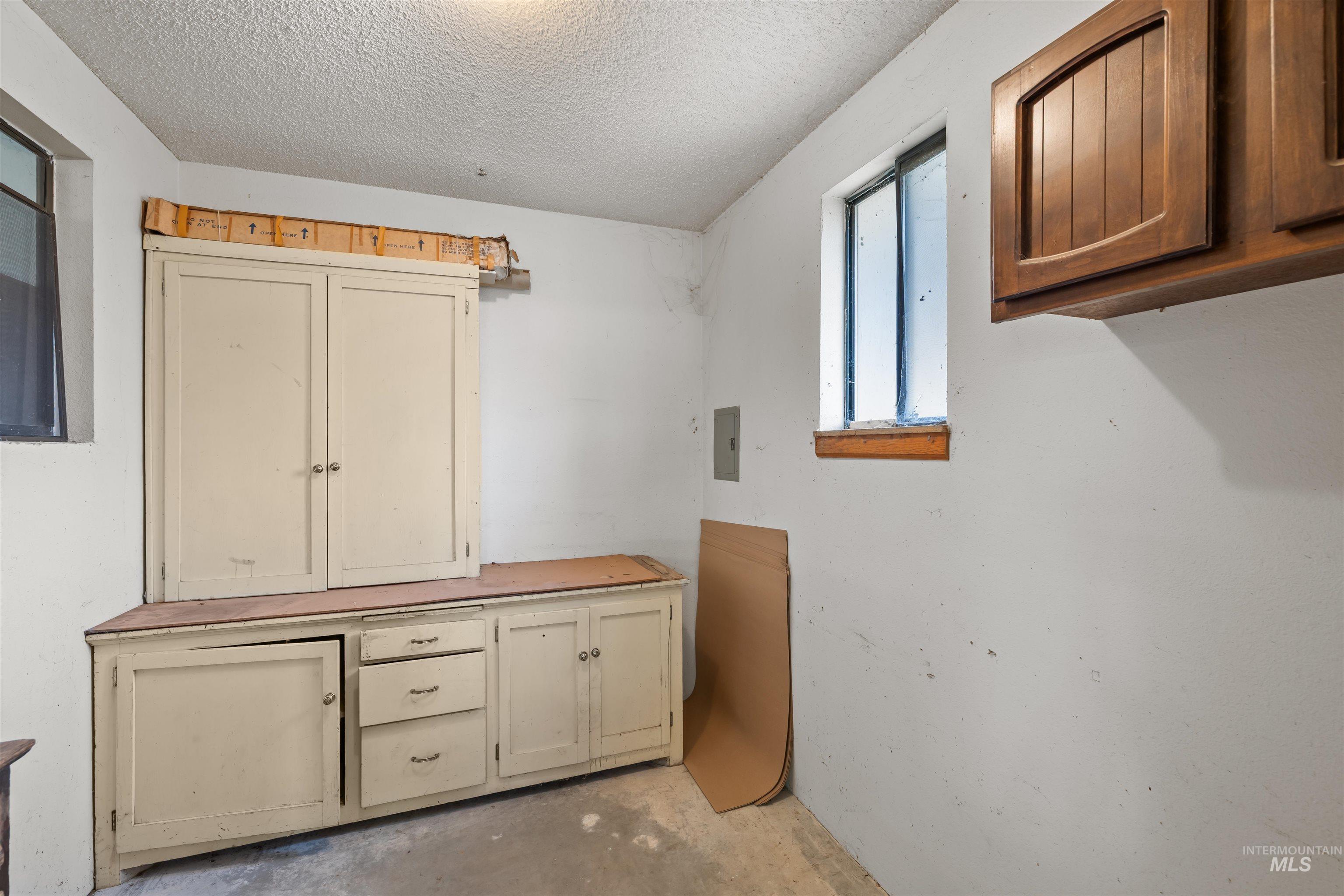 7144 West Diamond Street Boise, ID 83709 - Photo 29 of 47 Laundry area with concrete floors, a textured ceiling, and electric panel