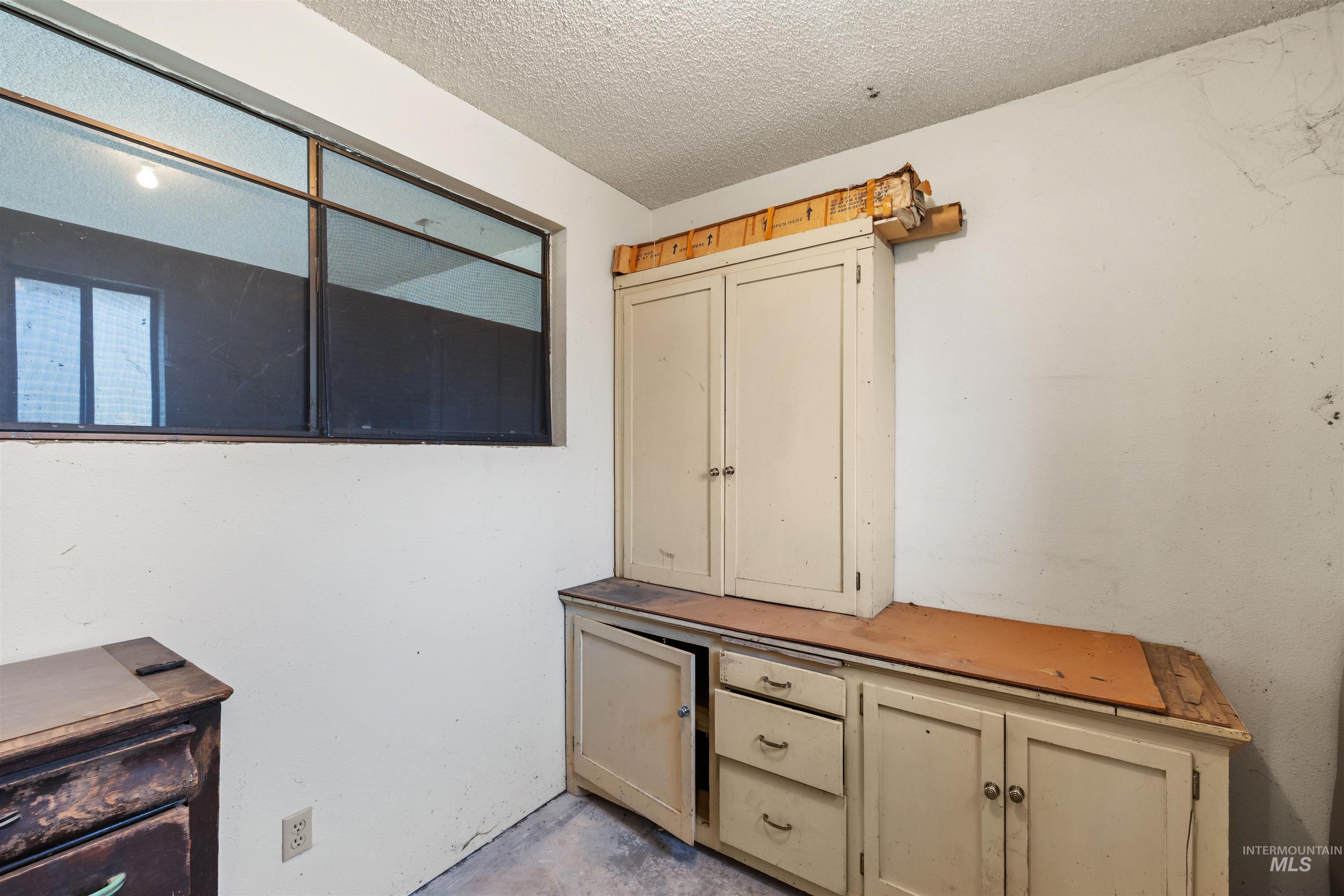 7144 West Diamond Street Boise, ID 83709 - Photo 30 of 47 Unfurnished office with unfinished concrete floors and a textured ceiling