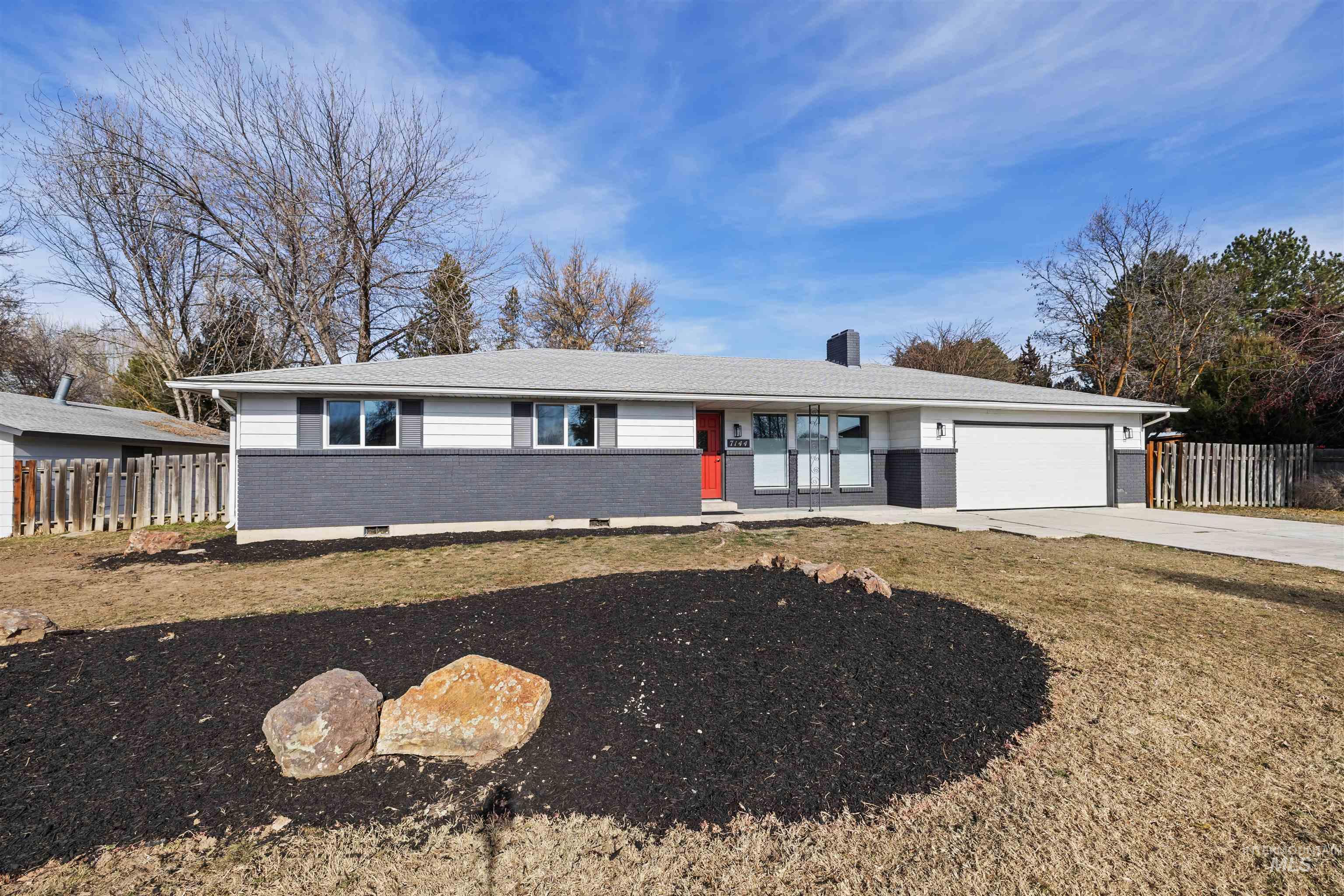 7144 West Diamond Street Boise, ID 83709 - Photo 3 of 47 Ranch-style home with brick siding, driveway, an attached garage, and a chimney