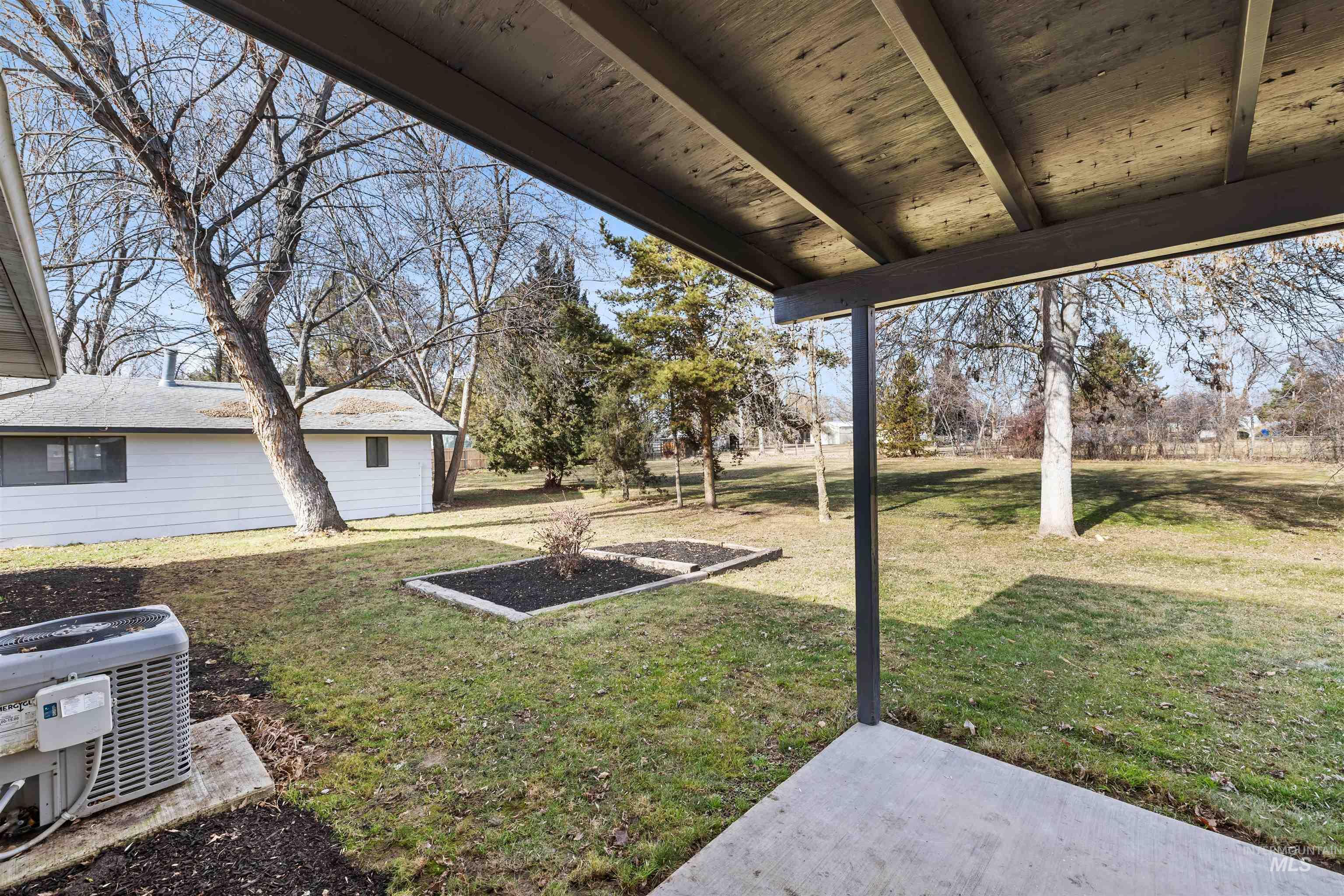 7144 West Diamond Street Boise, ID 83709 - Photo 31 of 47 View of green lawn featuring a patio area