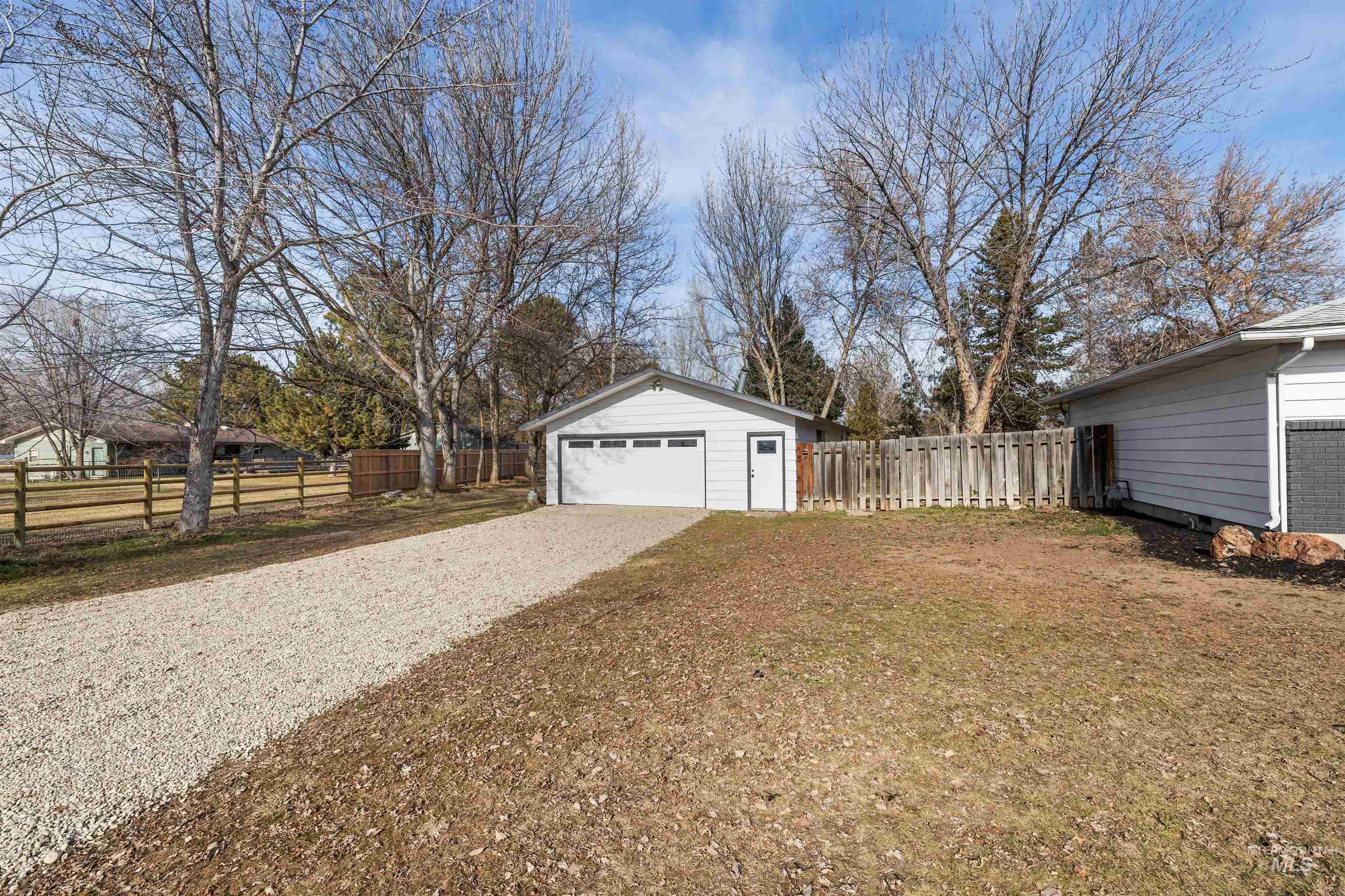 7144 West Diamond Street Boise, ID 83709 - Photo 34 of 47 View of yard with an outbuilding, a garage, and gravel driveway