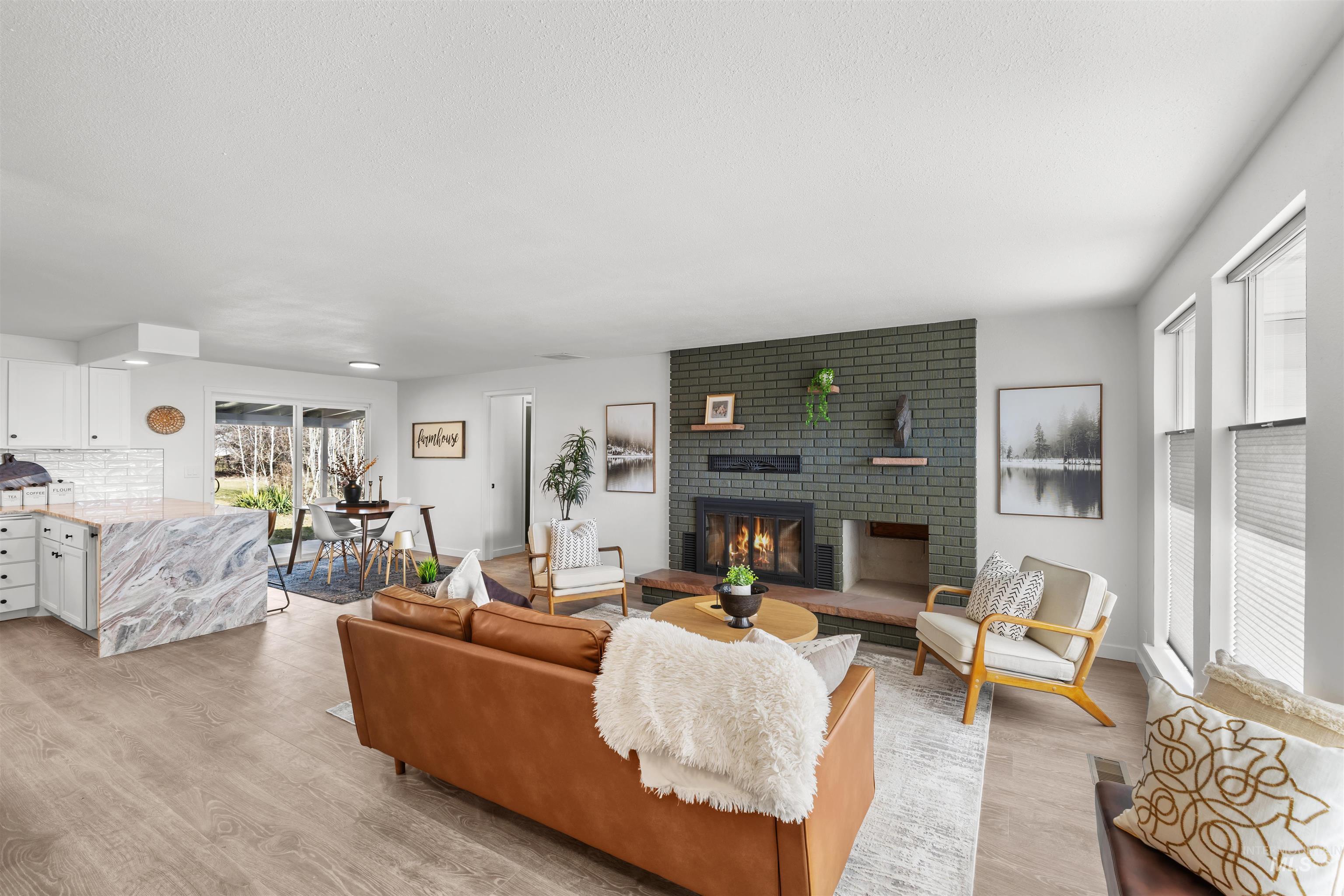 7144 West Diamond Street Boise, ID 83709 - Photo 5 of 47 Living area with light wood-style floors and a brick fireplace