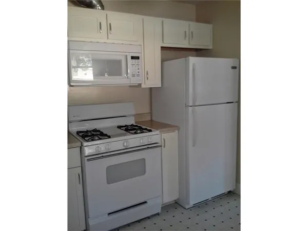 a white refrigerator freezer and a stove