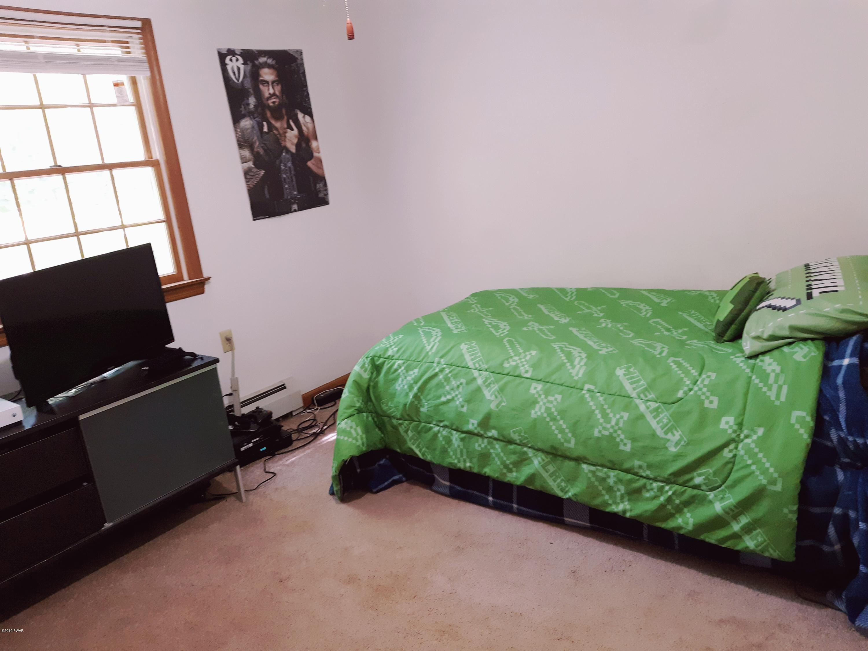 110 Weasel Road Dingmans Ferry, PA 18328 - Photo 29 of 39 a room with a bed and window