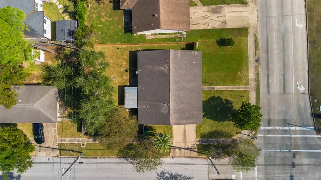 an aerial view of a house with a yard and potted plants