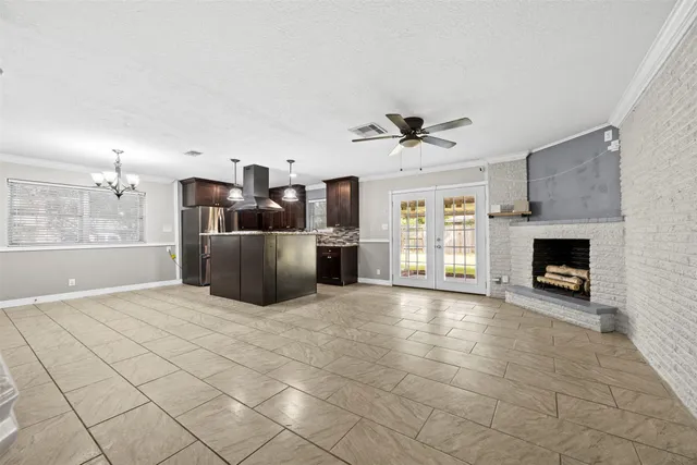 a large kitchen with cabinets and a fireplace