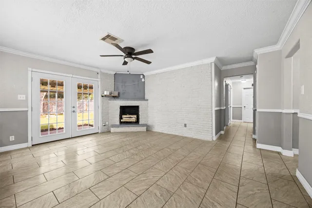 a view of empty room with cabinet and fireplace