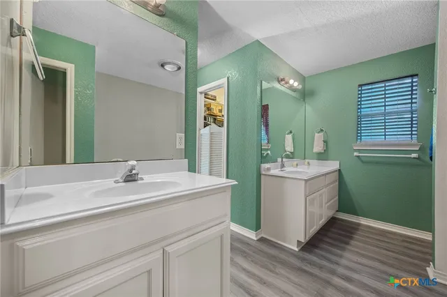 a bathroom with a sink mirror vanity and toilet